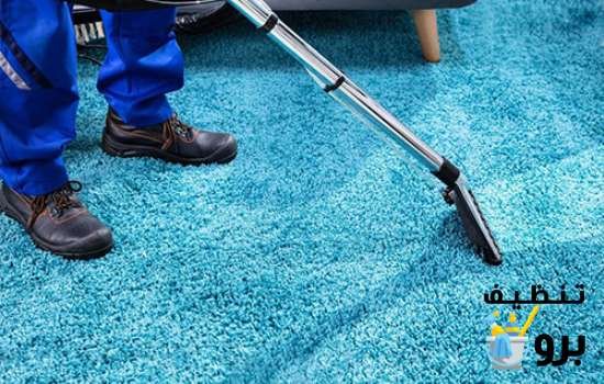 عامل النظافة يستخدم اجهزة تنظيف السجاد والموكيت المخصصة لها